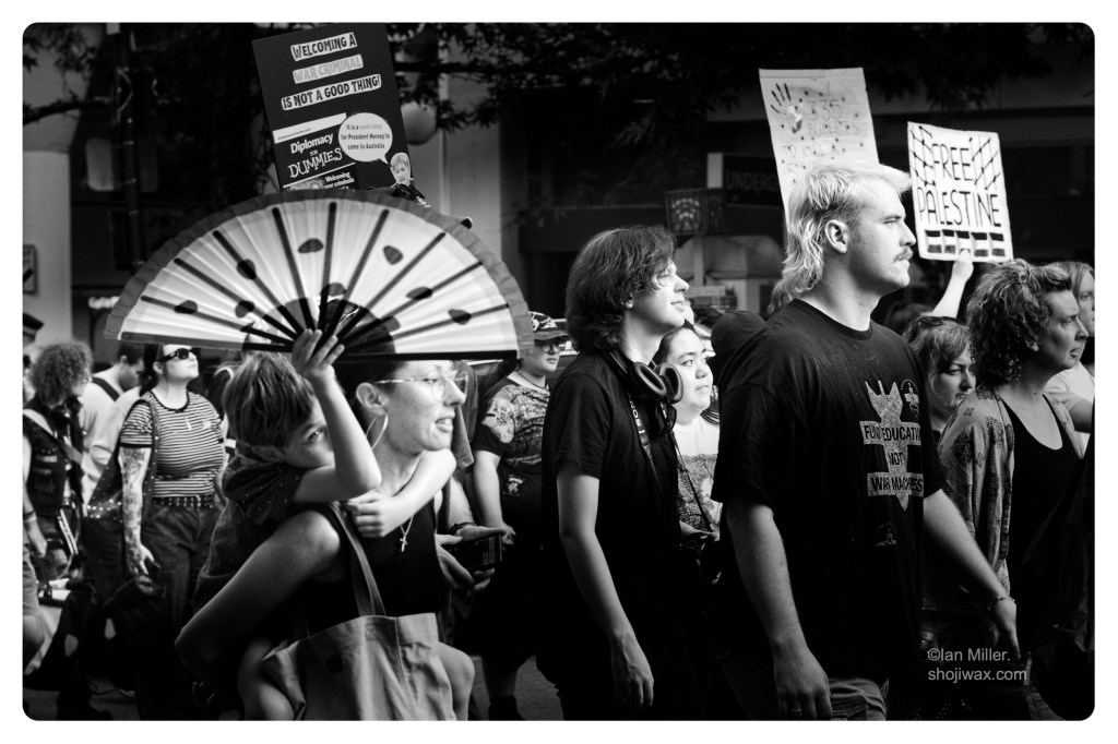 Monochrome high contrast photo of a group of protestors walking past