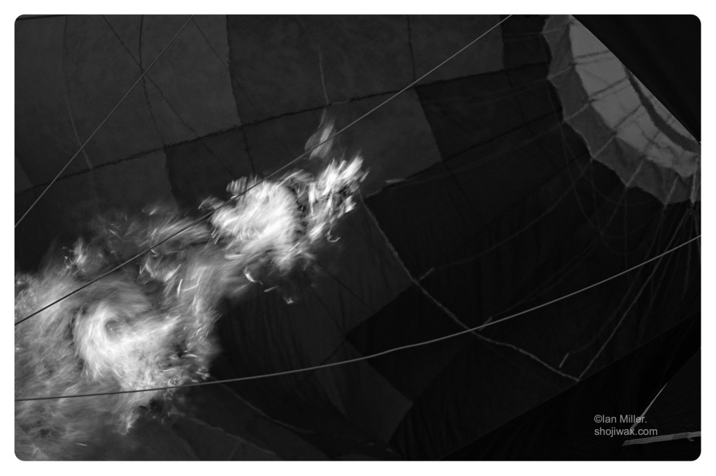 Monochrome photo of flames inside a hot air balloon.