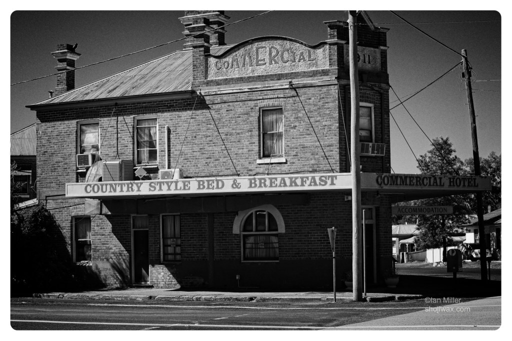 Monochrome photo of an old brick hotel on the corner of an Australian small country town.