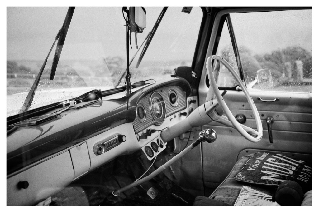 Monochrome photo of interior of an old classic car.