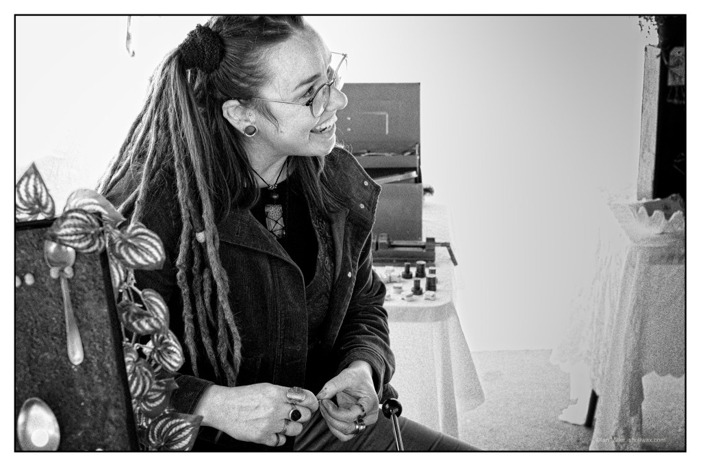Monochrome portrait photo of young woman with dreadlocks.